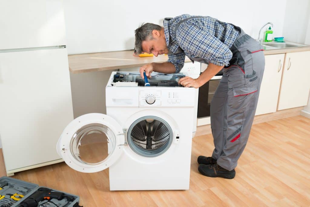 handyman checking washing machine